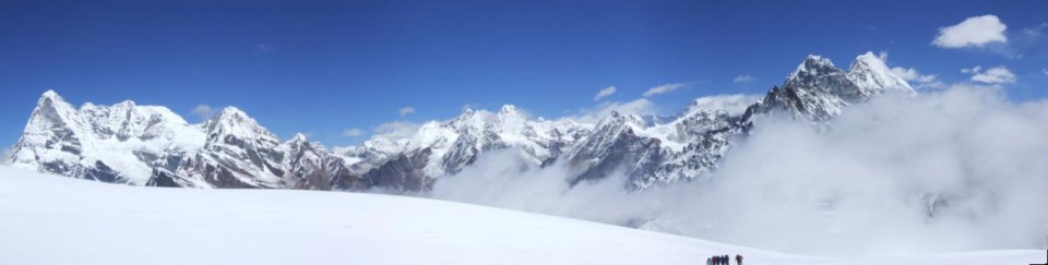 Trekkers dwarfed by the peaks above the Mera La