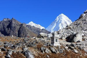 scores of memorials dot the slopes of the La, with Pumori in the background.