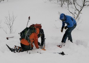 students in Norway using a transceiver to pinpoint a buried casualty
